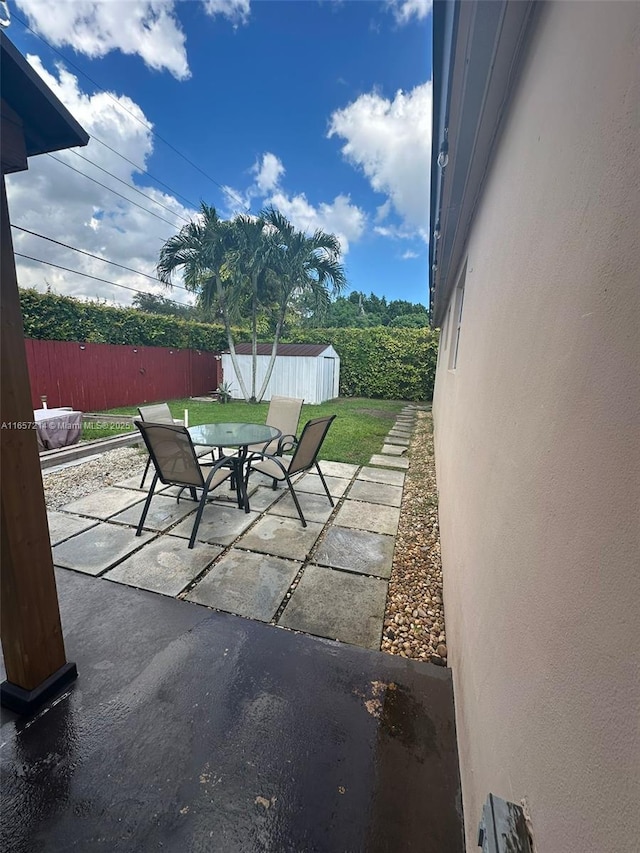 view of patio with a shed