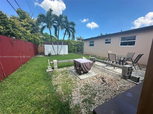 view of yard with a patio area and a storage shed