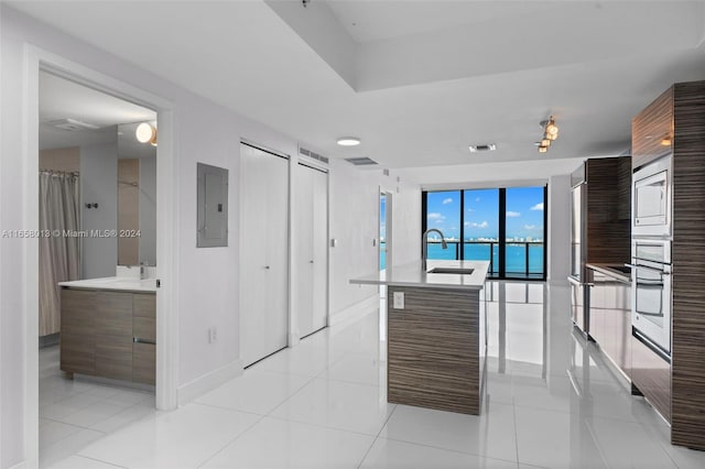 kitchen featuring electric panel, modern cabinets, light tile patterned flooring, and light countertops