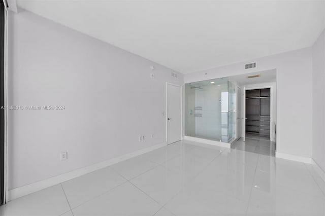 unfurnished bedroom with tile patterned floors, visible vents, and baseboards