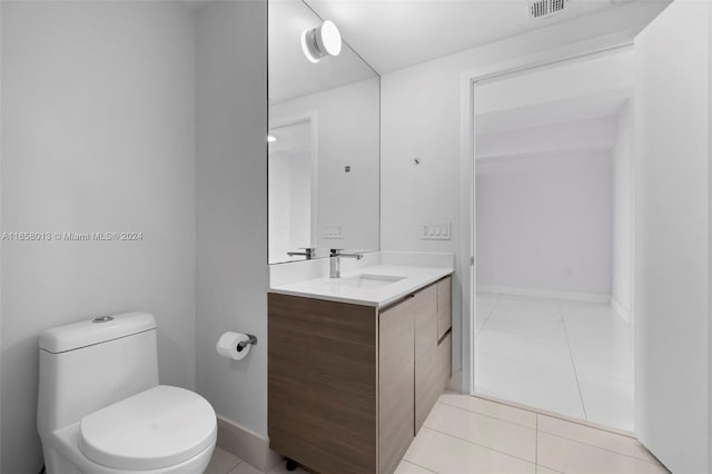 half bath with vanity, baseboards, visible vents, tile patterned floors, and toilet