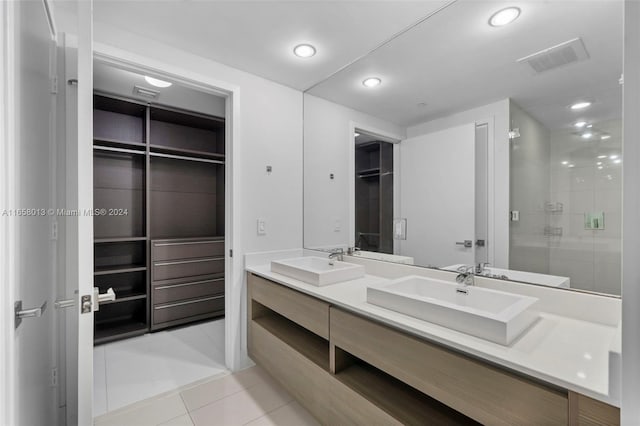 full bathroom featuring tile patterned flooring, visible vents, a shower stall, and a sink