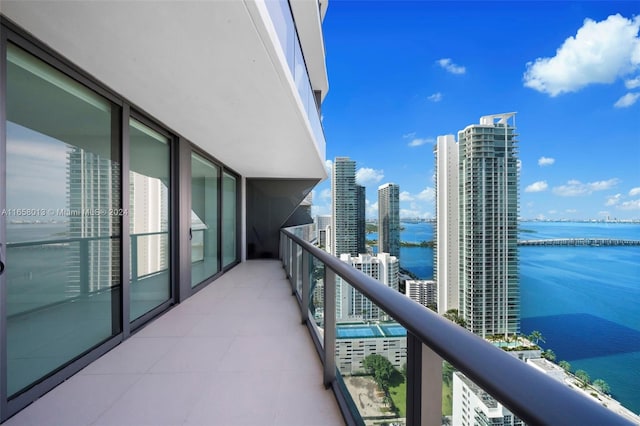 balcony featuring a city view and a water view