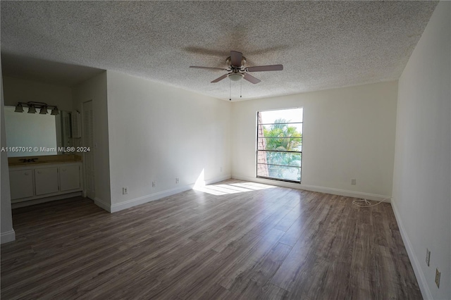 spare room with ceiling fan, dark hardwood / wood-style flooring, and a textured ceiling