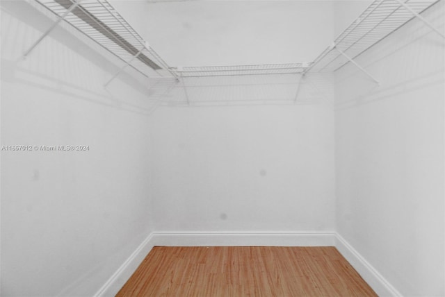 spacious closet featuring hardwood / wood-style flooring