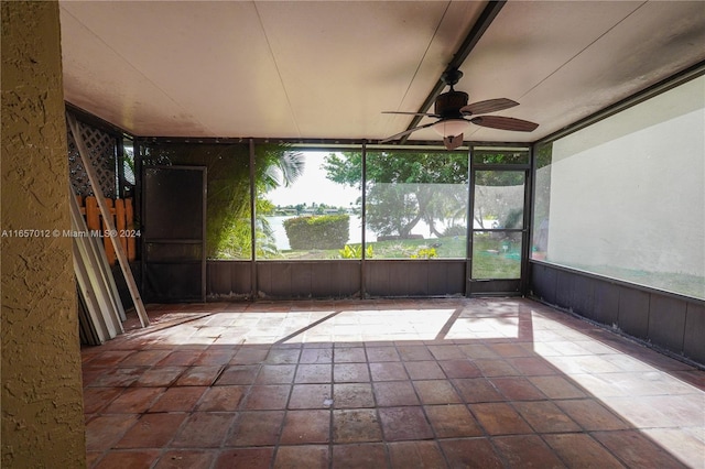 unfurnished sunroom featuring ceiling fan