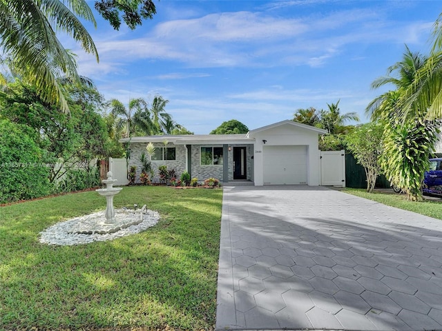 ranch-style house with a garage and a front yard