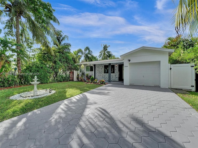 ranch-style home featuring a garage and a front yard