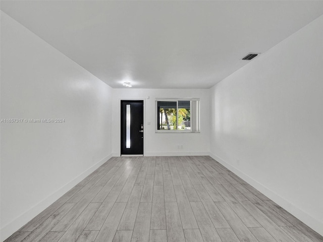 spare room featuring light wood-type flooring