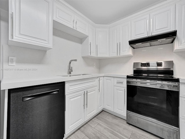 kitchen featuring white cabinetry, stainless steel appliances, sink, and light hardwood / wood-style floors