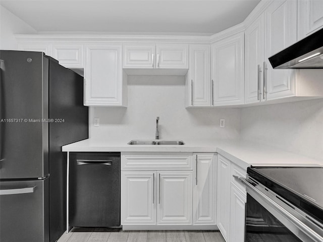 kitchen with ventilation hood, white cabinetry, stainless steel appliances, and sink