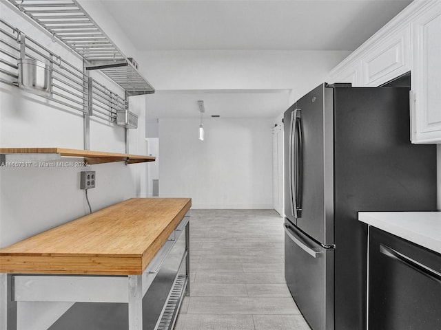 kitchen with appliances with stainless steel finishes, light hardwood / wood-style flooring, and white cabinets