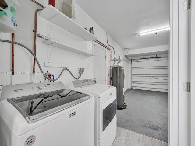 washroom featuring washing machine and clothes dryer and water heater