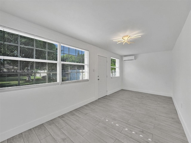 foyer featuring light hardwood / wood-style flooring and a wall unit AC