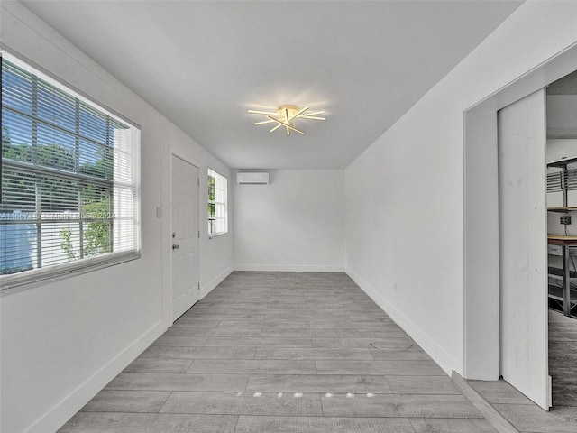 entryway featuring a wall mounted AC and light hardwood / wood-style floors