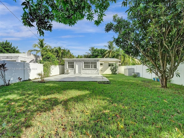 back of house featuring a patio area and a yard