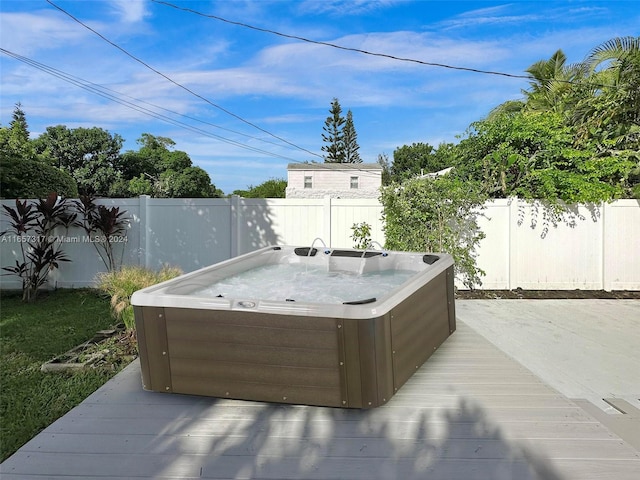 wooden deck featuring a hot tub