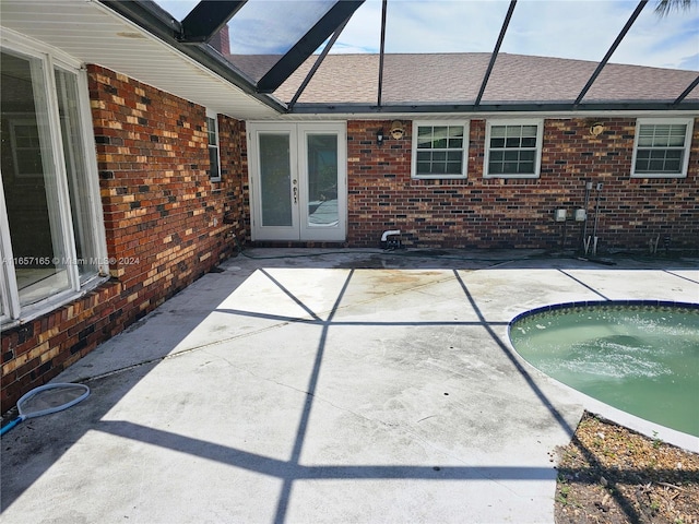 view of patio / terrace with a hot tub and french doors