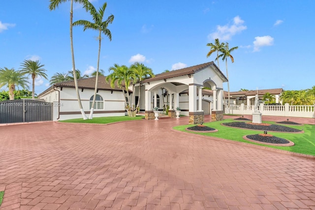 mediterranean / spanish home with a front lawn