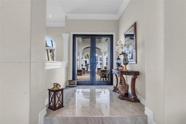 foyer entrance featuring ornamental molding and french doors