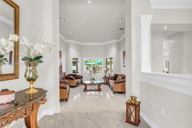 living room featuring ornamental molding and ornate columns