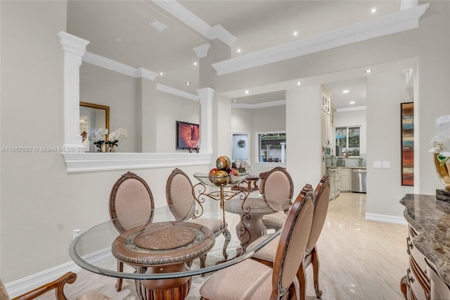 dining room featuring crown molding and decorative columns