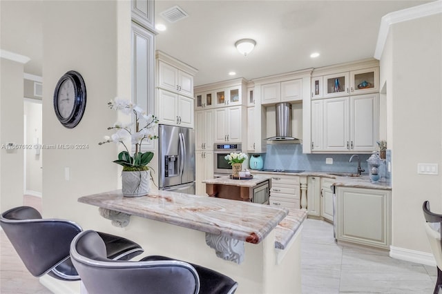 kitchen with a kitchen breakfast bar, kitchen peninsula, appliances with stainless steel finishes, and wall chimney range hood