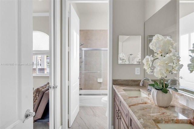 full bathroom featuring combined bath / shower with glass door, vanity, and toilet