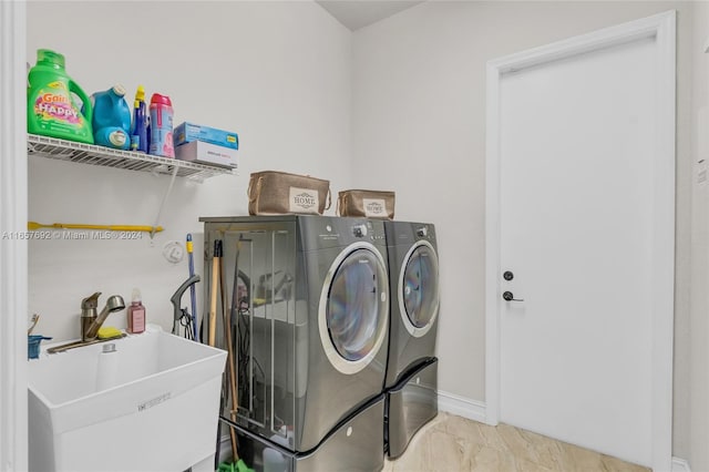 washroom featuring washer and dryer and sink