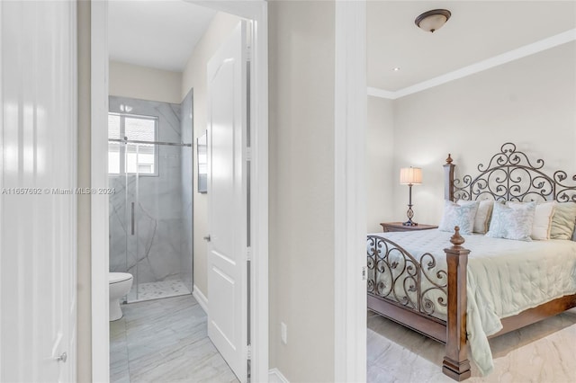 bedroom with ensuite bath and crown molding