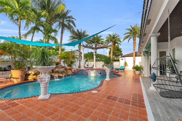 view of swimming pool featuring pool water feature, an in ground hot tub, and a patio area