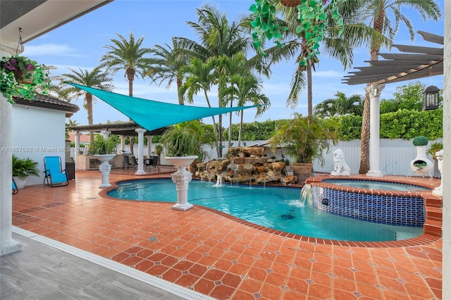 view of pool with a patio, an in ground hot tub, a pergola, and pool water feature