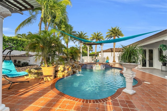 view of swimming pool with pool water feature and a patio area