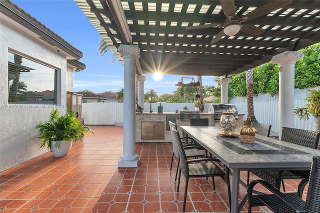 view of patio / terrace with exterior kitchen, a pergola, a grill, and ceiling fan