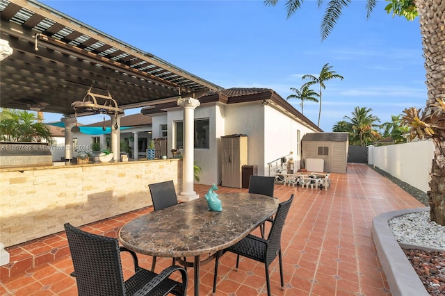 view of patio / terrace featuring ceiling fan and a shed