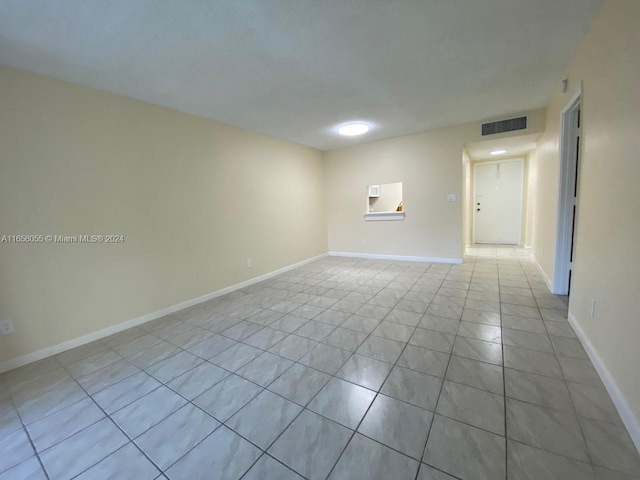 unfurnished room with light tile patterned floors