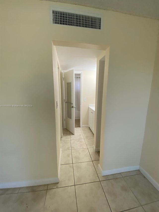 6071 NW 61st Ave Unit 107, Tamarac, FL 33319 - hall with baseboards and light tile patterned flooring