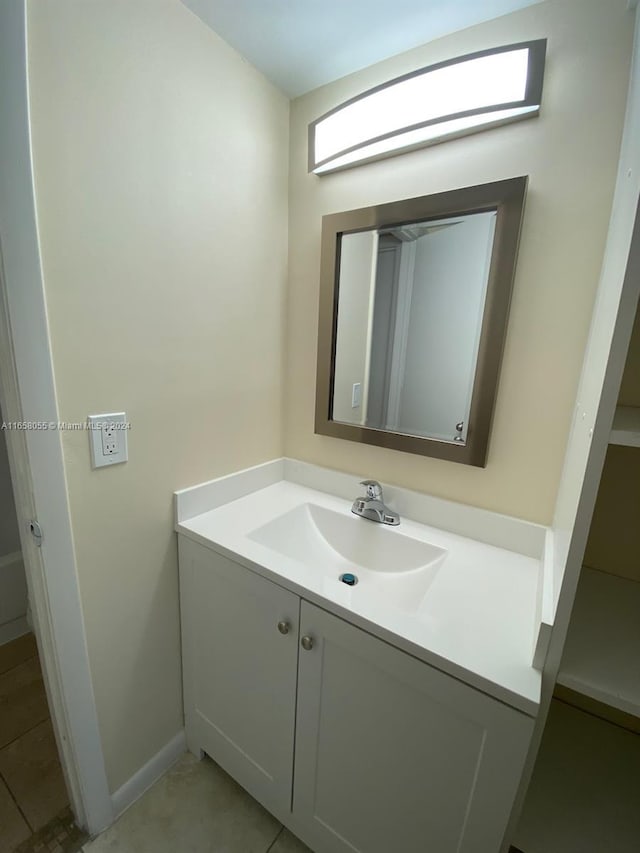 6071 NW 61st Ave Unit 107, Tamarac, FL 33319 - bathroom featuring vanity, baseboards, and tile patterned floors