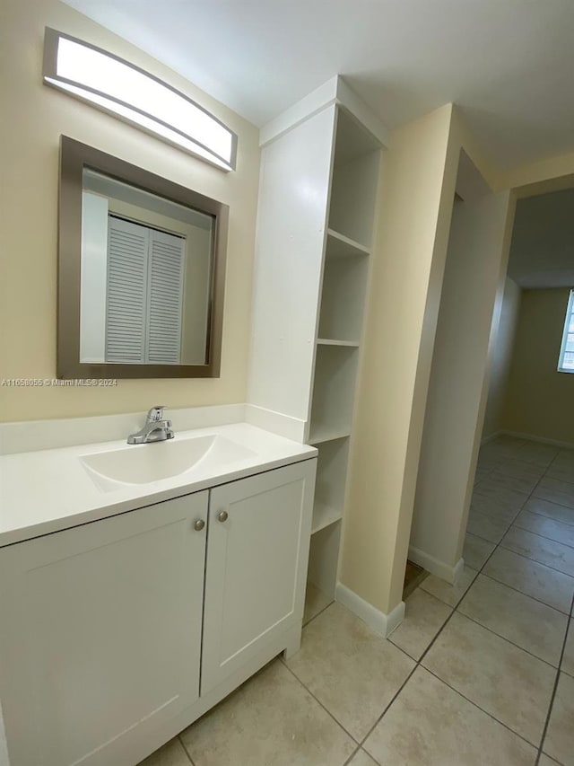 6071 NW 61st Ave Unit 107, Tamarac, FL 33319 - bathroom with tile patterned flooring, vanity, and baseboards