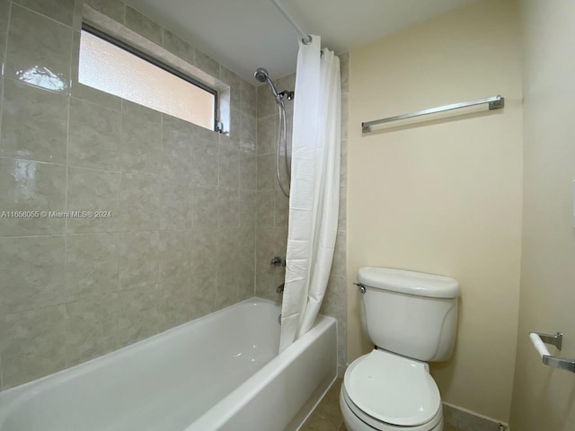 6071 NW 61st Ave Unit 107, Tamarac, FL 33319 - full bathroom with toilet, shower / bath combo with shower curtain, and baseboards