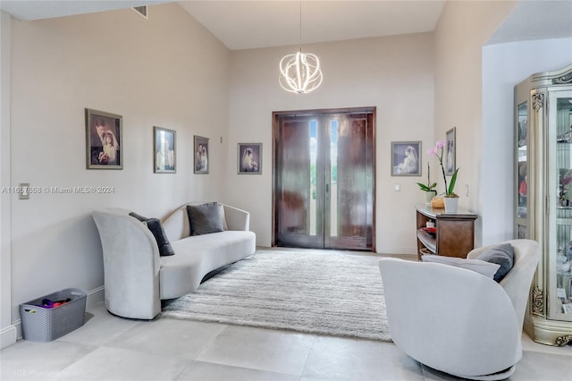 living room with high vaulted ceiling and a chandelier