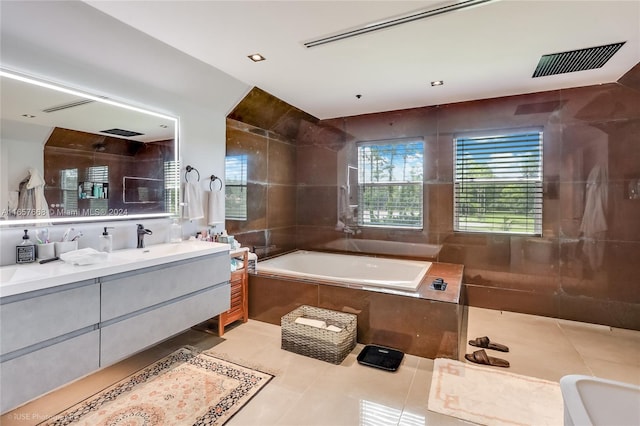 bathroom with vanity, tile walls, tile patterned floors, and shower with separate bathtub