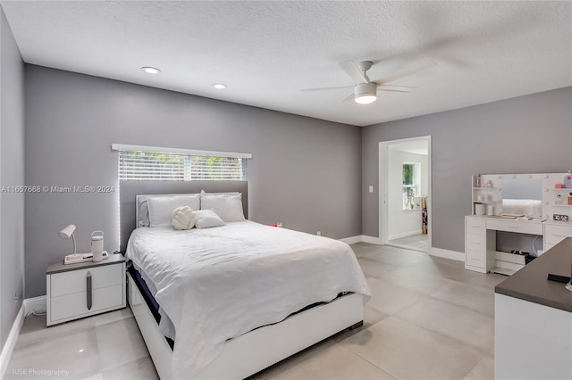 bedroom with a textured ceiling and ceiling fan