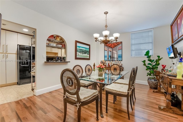 90 Edgewater Dr Unit 501, Coral Gables, FL 33133 - dining room featuring a chandelier and light wood-type flooring
