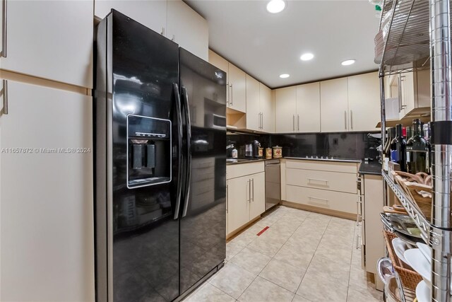 90 Edgewater Dr Unit 501, Coral Gables, FL 33133 - kitchen with black refrigerator with ice dispenser, dark countertops, stainless steel dishwasher, backsplash, and light tile patterned flooring
