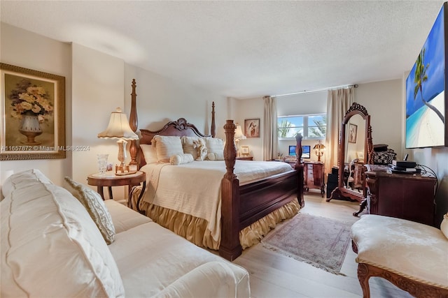 90 Edgewater Dr Unit 501, Coral Gables, FL 33133 - bedroom featuring light wood-type flooring and a textured ceiling
