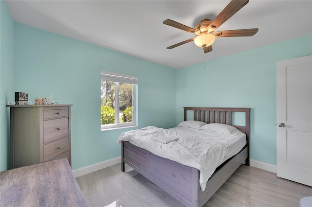 bedroom featuring ceiling fan and light hardwood / wood-style flooring