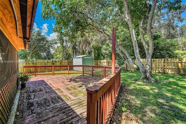 deck with a storage shed and a lawn