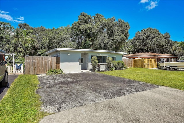 ranch-style house with a front lawn