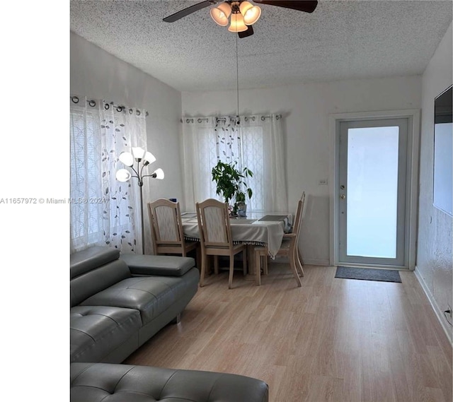 living room featuring light wood-type flooring, a wealth of natural light, and ceiling fan